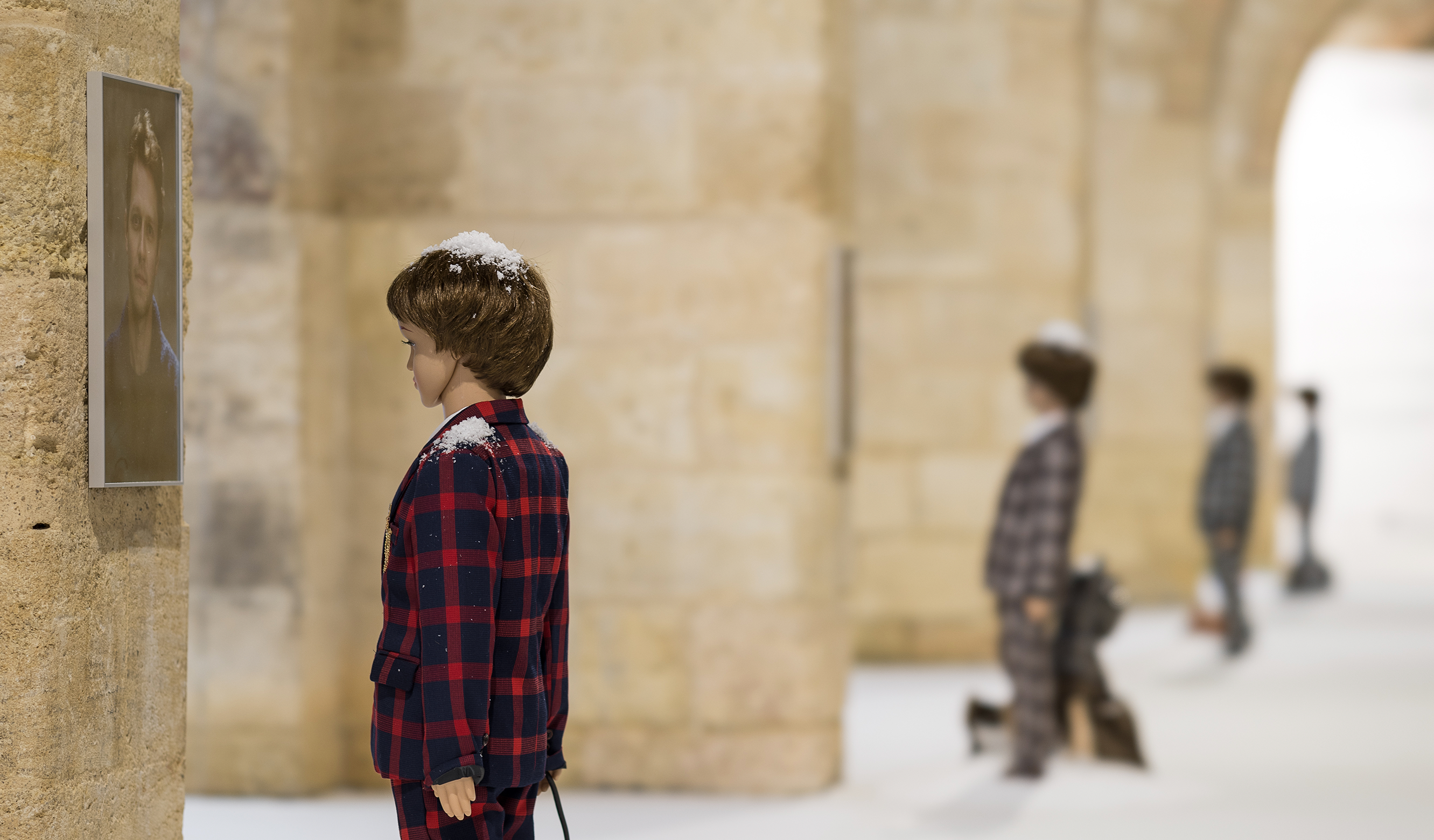 Vue de l'exposition "Auto" de Nina Beier, Capc musée d'art contemporain. Plusieurs mannequins d'enfants en costumes luxueux regardent des portraits accrochés au mur.